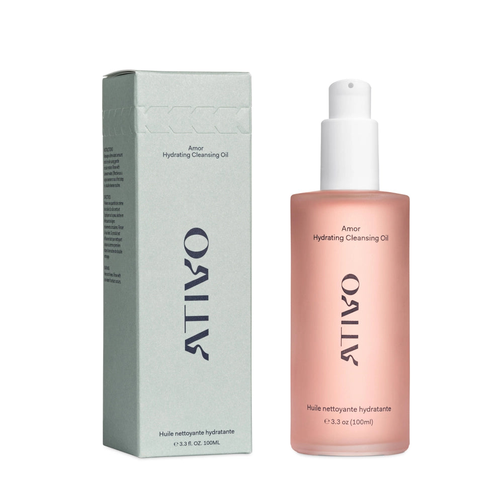 Pink Amor Hydrating Cleansing Oil with green box sitting on a white background
